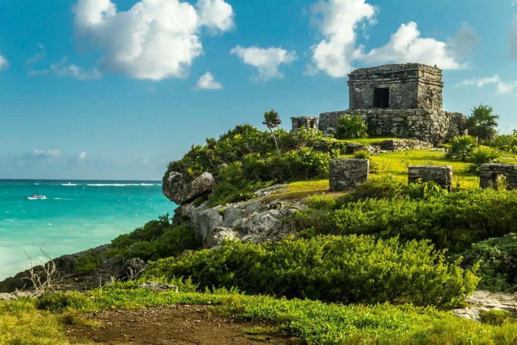 Explore the ancient Mayan ruins of Tulum set against a stunning beach backdrop.